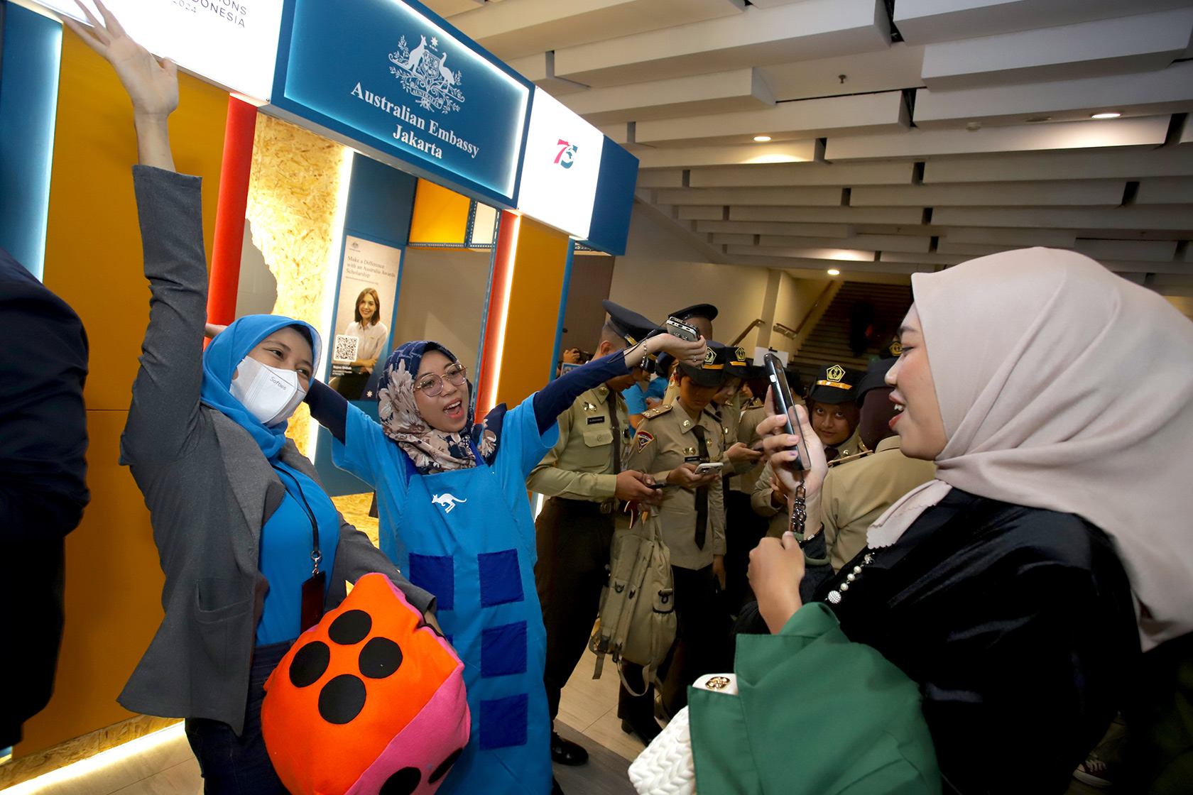 The Australian Embassy booth comes alive with vibrant energy as visitors dive into interactive flashcard games. Laughter and learning go hand in hand, creating a lively and welcoming atmosphere for all.