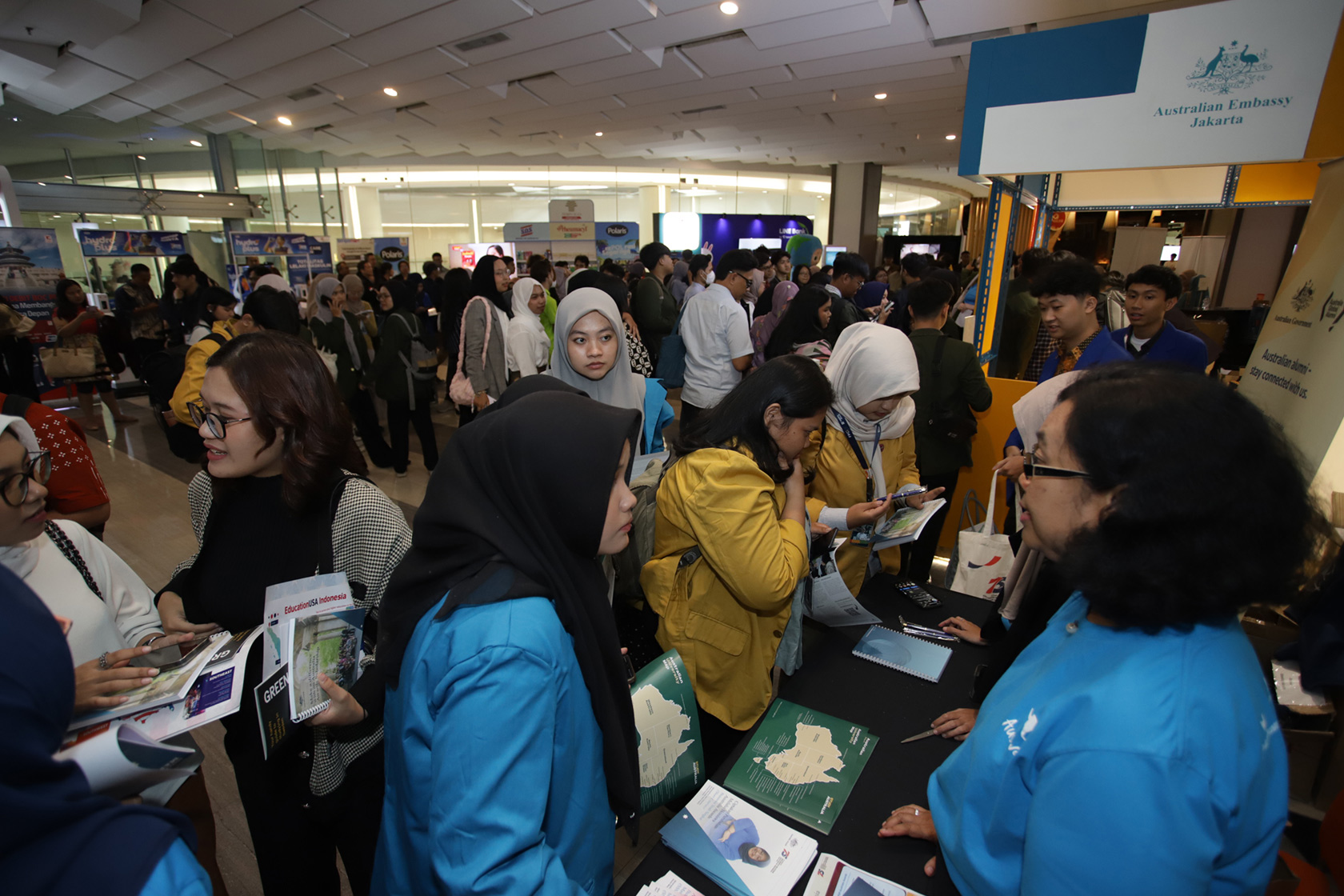 Excitement fills the air as visitors gather at the booth, eager to learn more about the life-changing opportunities offered by the Australia Awards Scholarships and Short Courses.