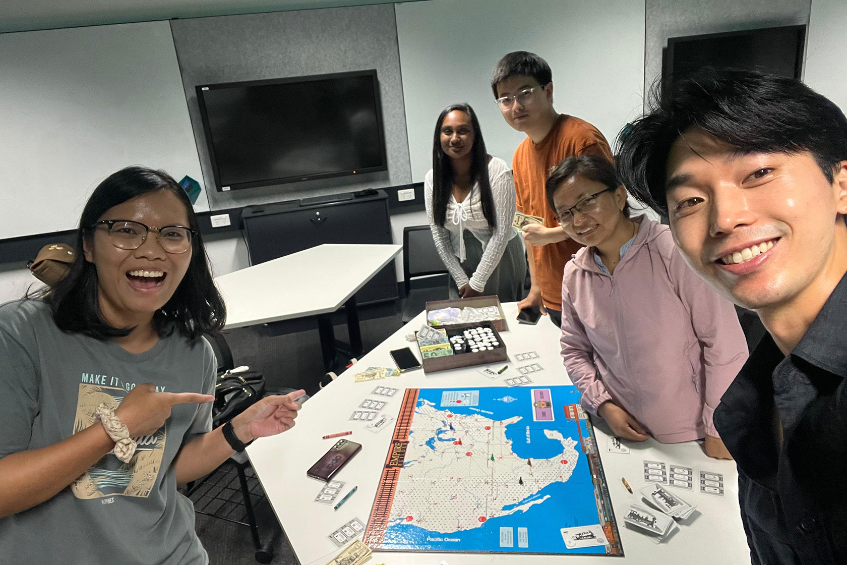 Erni and her University of Sydney classmates play a board game to gain a deeper understanding of transportation policy, planning, and deployment.