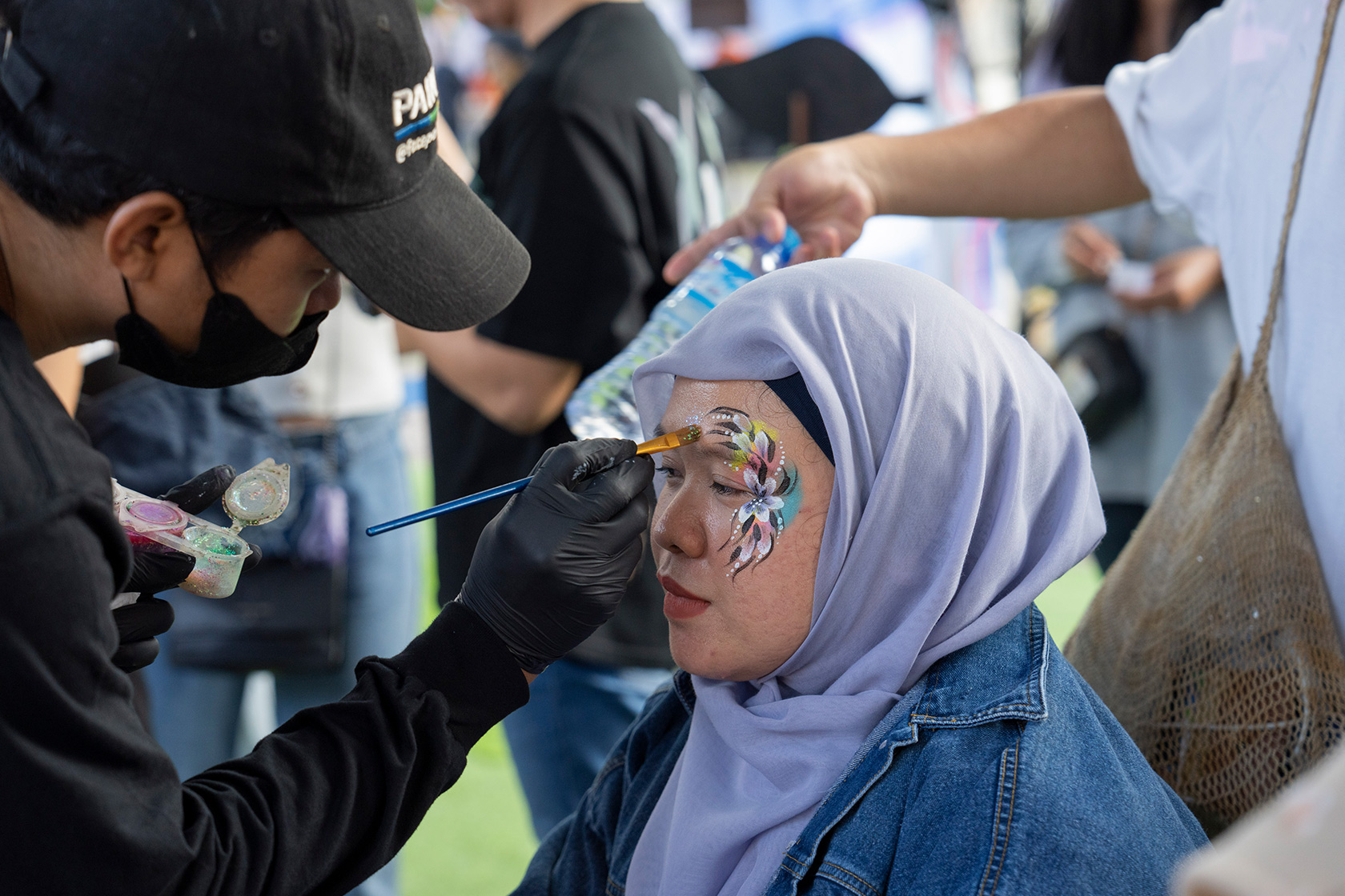 An Alumna joins in the fun of festivities with face painting.