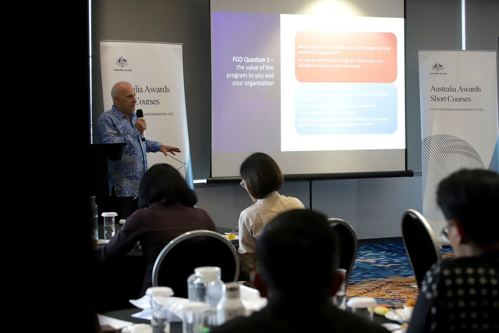 Participants engage intently with the course facilitator's session.