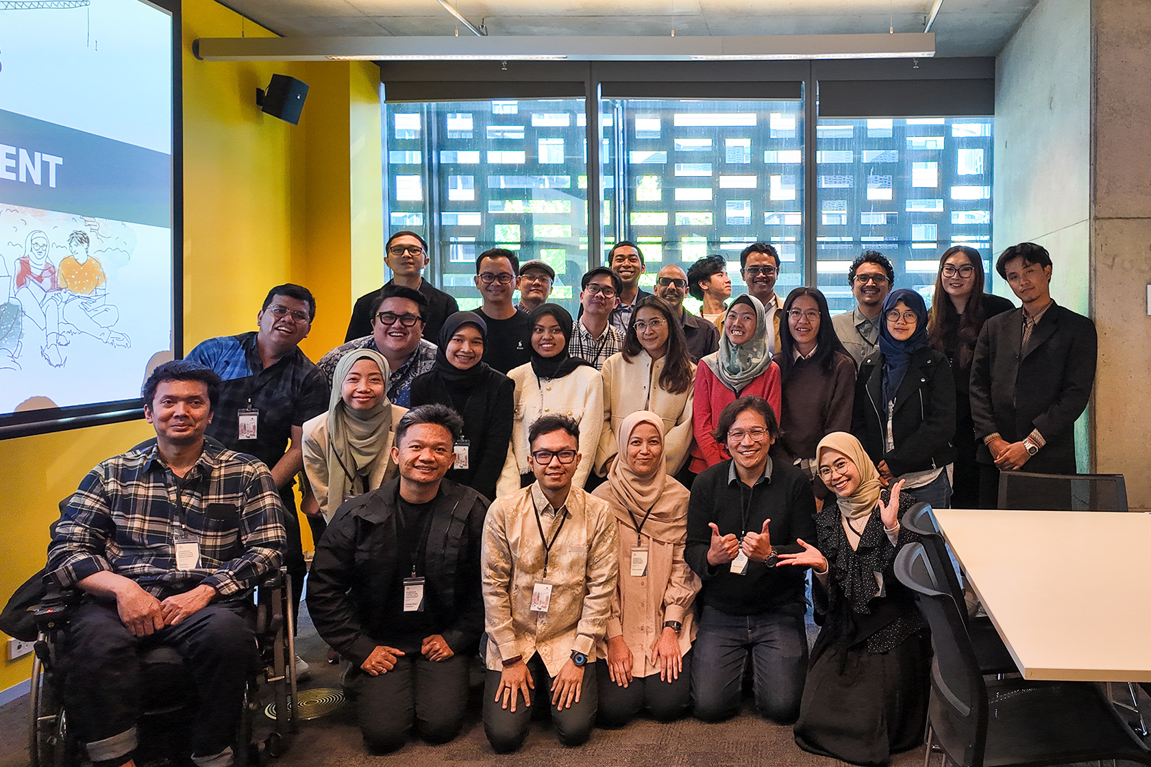 Participants from the Sydney workshop come together for a cheerful group photo.