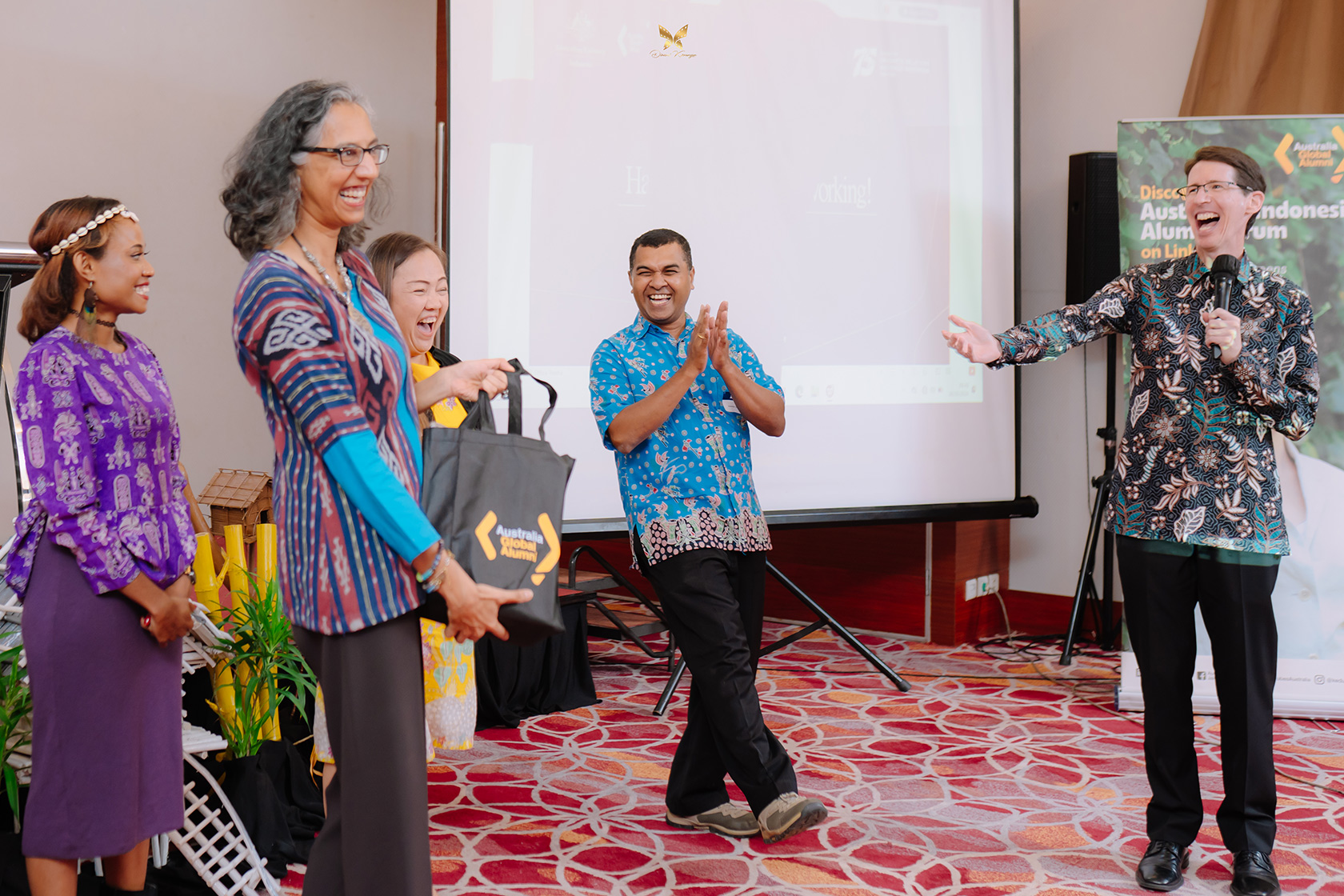 The networking dinner in Manokwari is filled with joyful camaraderie.