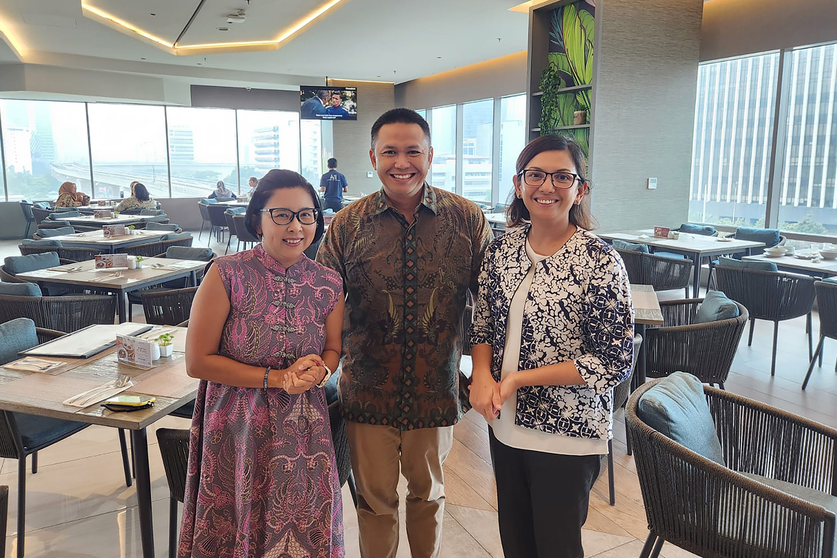 Gender Equality and Disability (GEDSI) Adviser Lia Marpaung takes a picture together with training participants after the training session ends.