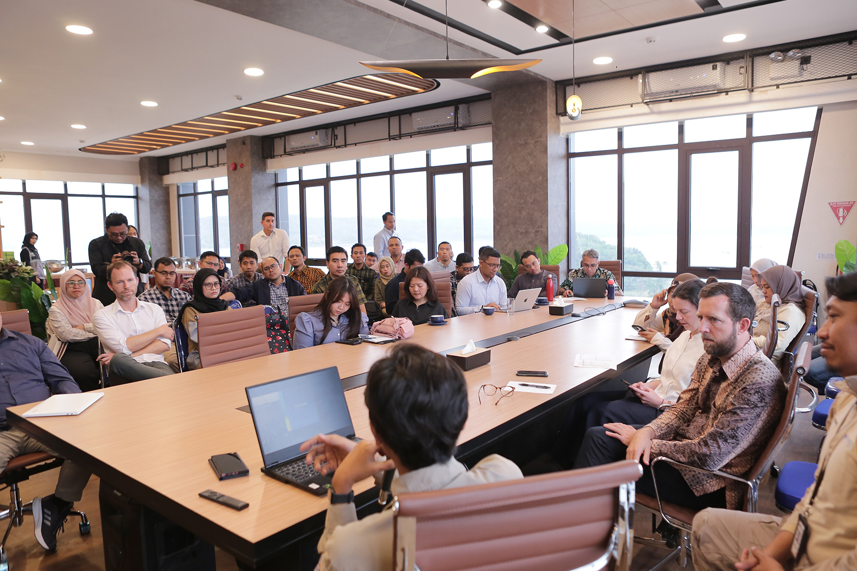 Participants attentively listen to a presentation on innovative ideas for climate finance to support Indonesia's transition to a green economy.