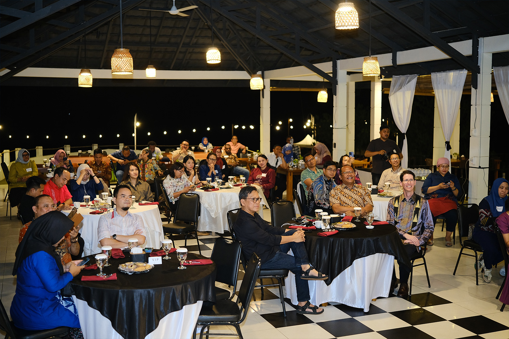 Participants focus intently on the speaker, absorbing valuable insights.