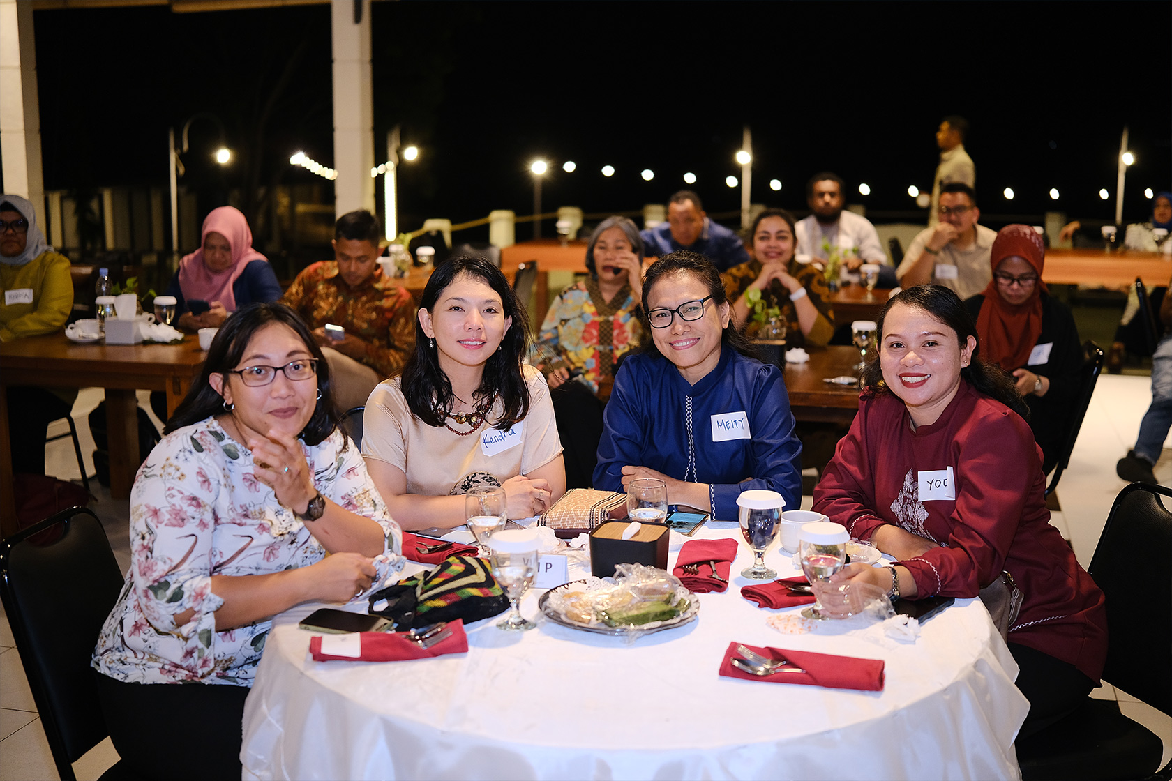 A group of networking participants posing happily for a photo.