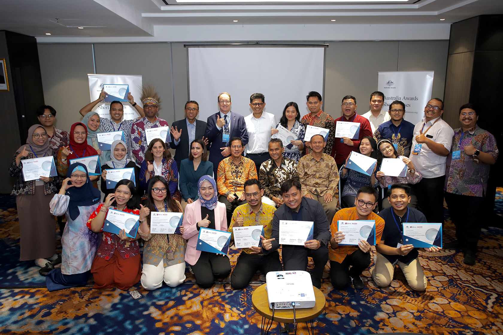 Participants proudly pose for a group photo with their certificates, now officially part of the Australia Awards alumni.