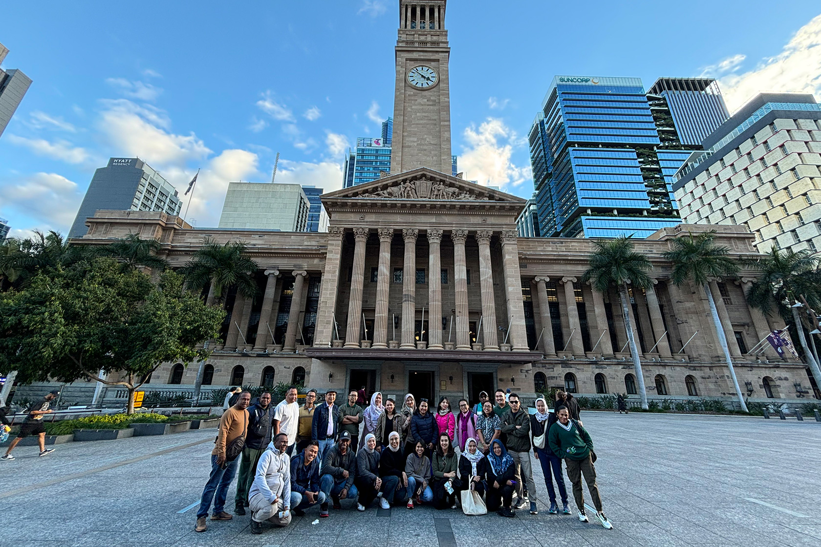 Our short course participants pose together with the Brisbane City Council building in the background.