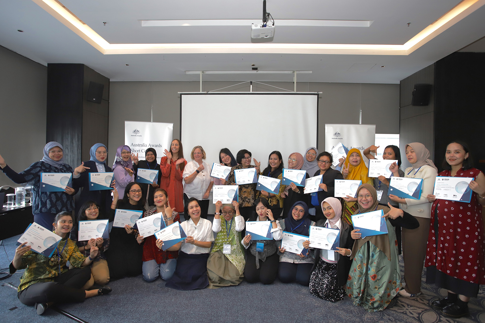 Smile! Participants proudly display their certificates, marking their official entry into the esteemed Australia Awards alumni community.