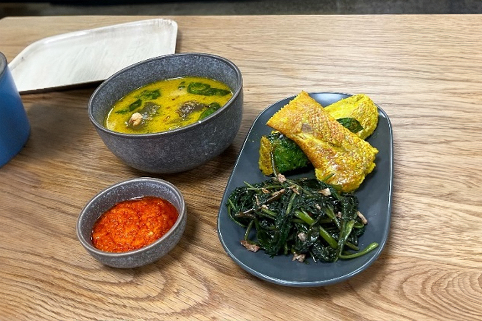 A snapshot of delicious looking papeda with turmeric fish soup and stir-fried morning glory