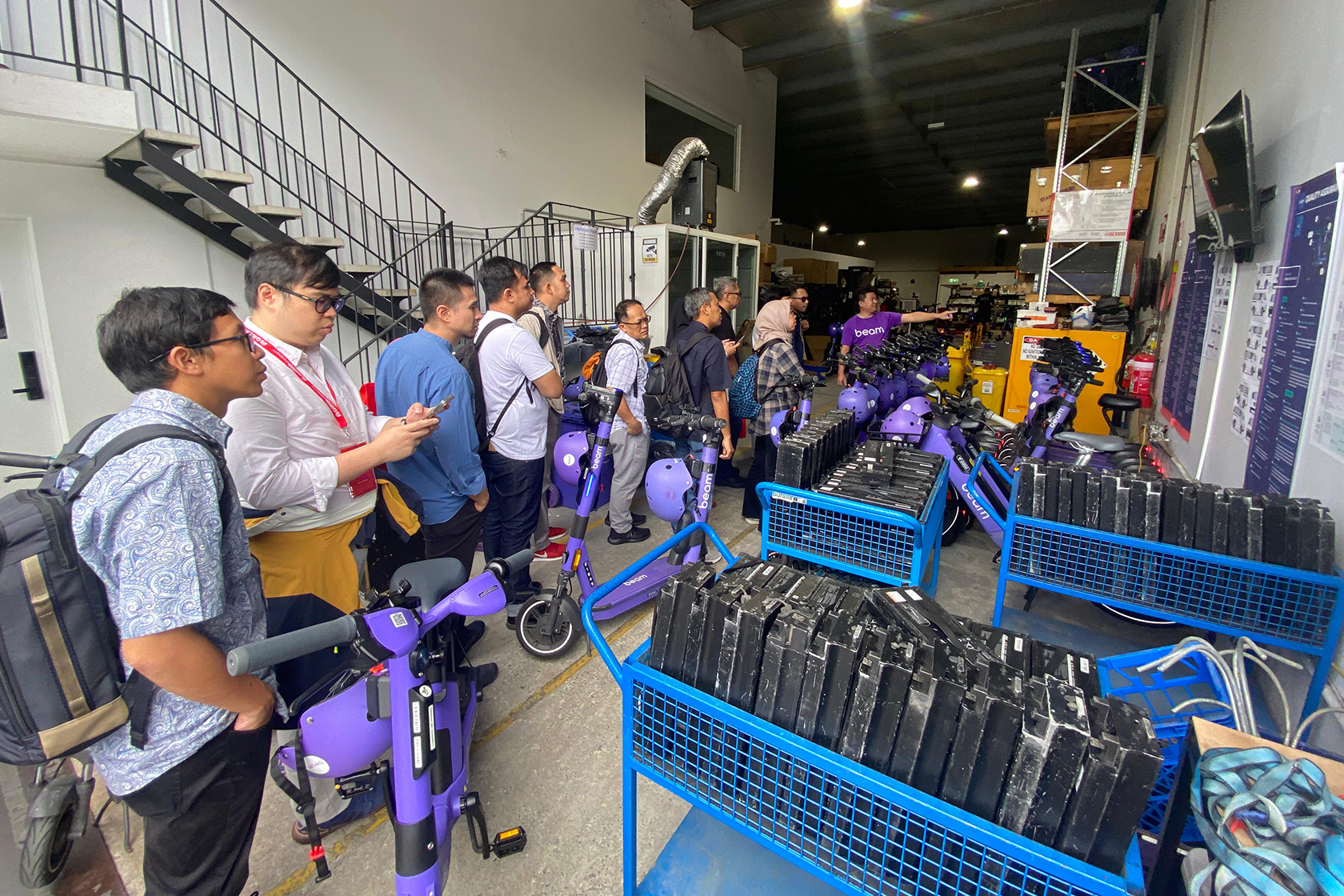 Course participants engage in a discussion during their visit to an electric vehicle site in Australia