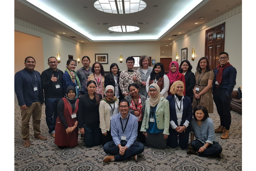 A group of people taking group photo inside the room