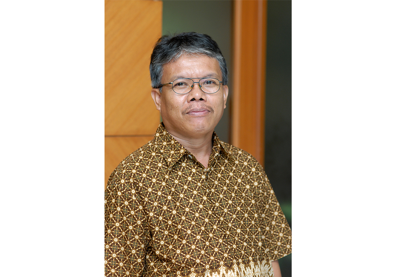 A man with glasses and brown batik shirt